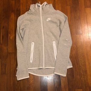 A grey and white nike zip up jacket.